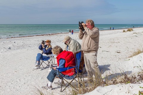 Men and women using sextants on the white sand beach of Indian Shores, Florida, USA, North America