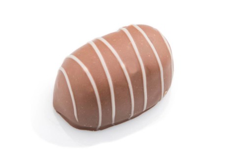 Single chocolate candy isolated on white background. side view, close up