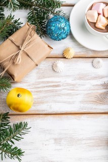 Christmas or New Year frame composition. Decorations, box, balls, cinnamon, ribbons, fir and spruce