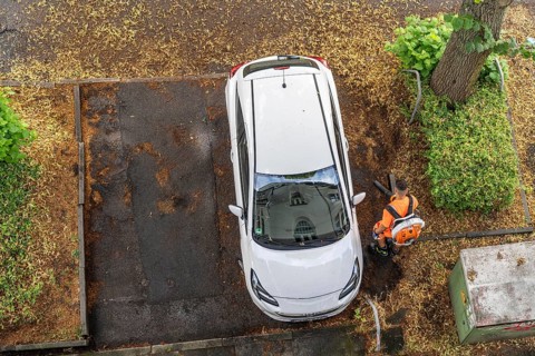 Street cleaning, an employee of the municipal city cleaning service, cleans pavements and parking
