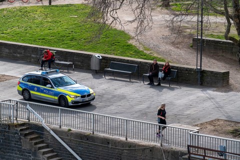 Effects of the coronavirus crisis, empty shopping street, police patrol car, Rhine bank
