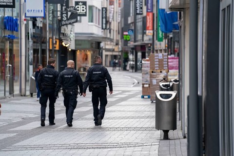 Effects of the coronavirus crisis, empty shopping street, patrol from the public order office,