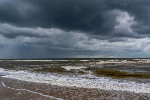 Beach, dark storm clouds, choppy sea, autumn on the North Sea in North Holland, between the towns
