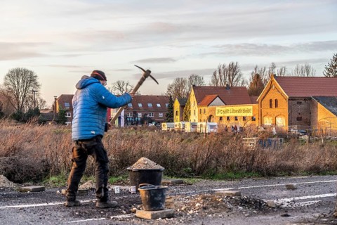 Climate activists chop up the asphalt of a road to erect obstacles, barricades, to prevent the
