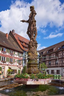 Knights on the market fountain, a tubular fountain with half-timbered houses in Gengenbach, Black