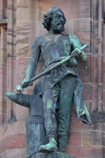 Sculpture Ironworker with anvil and hammer as a symbol for ironworks, statue, figure, bronze,