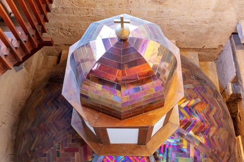 Colourful church dome with stained glass and a cross, geometric patterns and bright colours,