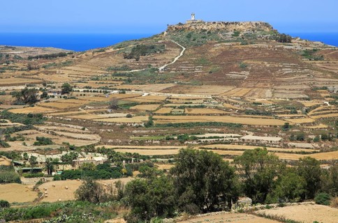 Rural landscape view from Zebbug to hilltop Ta 'Gurdan, Gordan or Gordon lighthouse, Gozo, Malta,
