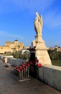 Angel San Rafael statue on Roman bridge with views cathedral, Cordoba, Spain, Europe