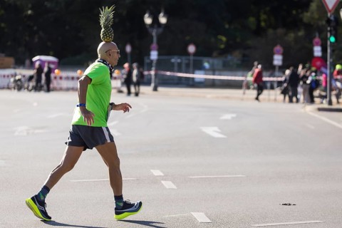 Pineapple Marathon Runner (Moshe Lederfien) balances a pineapple on his head during the run at the