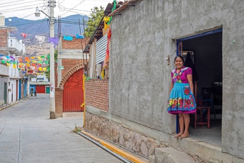 San Miguel del Valle, Oaxaca, Mexico, Epifania Hernandez Garcia stands in the doorway of her shop,