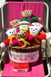 Homemade woollen teddy bears for sale with honesty money box, Cornwall, England, UK