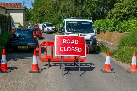 Road Closed sign due to BT maintenance work in street, Shottisham, Suffolk, England, UK
