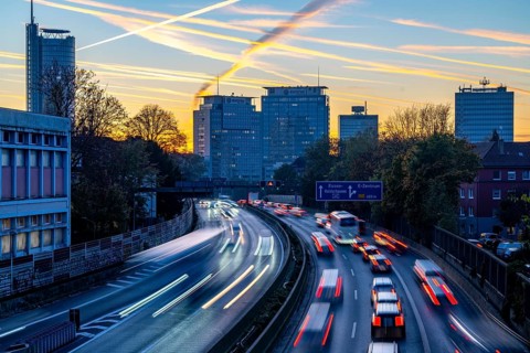 Evening traffic, partly with traffic jams, slow-moving traffic on the A40 motorway, skyline of