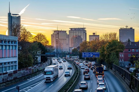 Evening traffic, partly with traffic jams, slow-moving traffic on the A40 motorway, skyline of