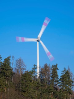Wind Turbine, on a ridge in a forest, taken with a long exposure to create an abstract blurred