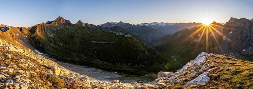 Panorama, mountain landscape at sunrise with sun star, view of mountain peaks of the Venediger