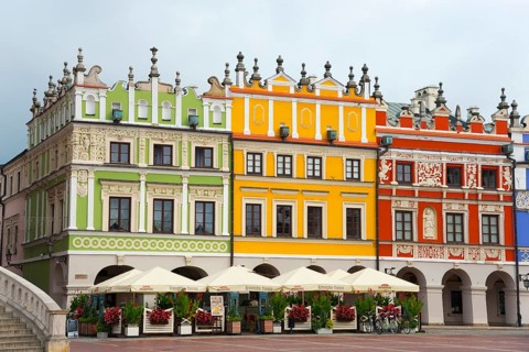 Historic Renaissance houses with colourful facades in a lively market scene, Great Market, Zamosc,