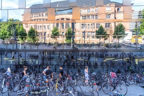 Bicycles parked in front of the reflecting facade of the University Library Freiburg im Breisgau,