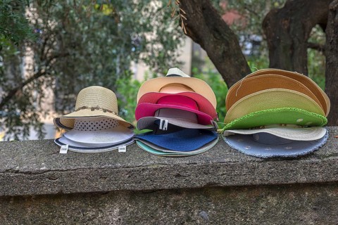 Sun hats on a wall for sale, Genoa, Italy, Europe