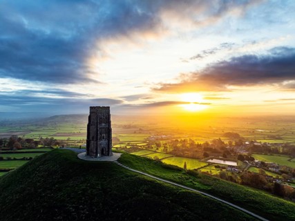 Sunrise over Glastonbury Tor from a drone at autumn, Glastonbury, Somerset, England, United