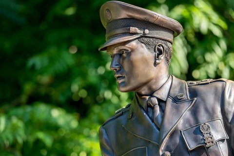 Bronze statue, monument to rock singer Elvis Presley, King of Rock 'n' Roll in uniform of the 3rd