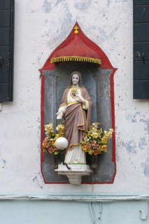 Chistus figure under a canopy on a house, Burano, Veneto, Italy, Europe
