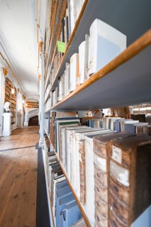 Close-up of bookshelves containing old books standing above a wooden floor, Weimar, Germany, Europe