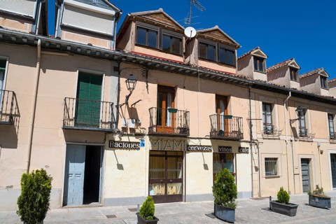 Sunny street scene with buildings, balconies and signs in a Spanish town, Calle de Jose Costa, San