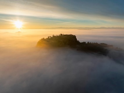 Aerial view of the Hegau volcano Hohentwiel with the upper fortress ruins as a silhouette at
