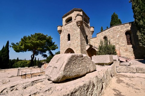 Monastery of Our Lady of Mount Filerimos, A medieval stone tower on a sunny day surrounded by