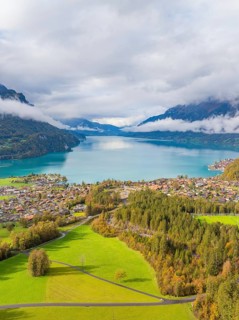 Painted village landscape with a lake and mountains in the background, Lake Brienz, Switzerland,