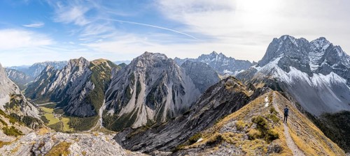 Panorama, view into Falzthurntal, mountaineer on a hiking trail on the ridge of Hahnkampl, mountain