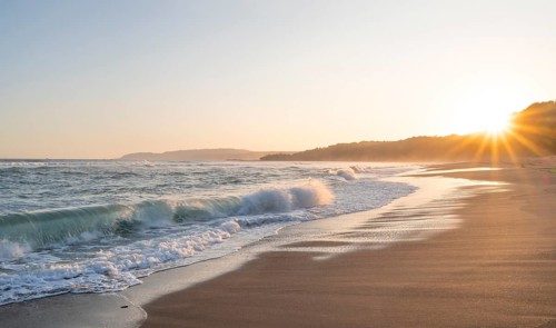 Sandy beach beach and sea at sunset, sun star, Playa Cocalito, coastal landscape, Pacific coast,