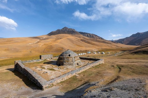 Historic caravanserai Tash Rabat from the 15th century, traditional yurts in the back between