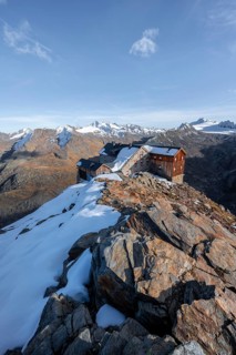 Snowy mountain landscape, mountain hut Ramolhaus in autumn with snow, in the evening light, view of