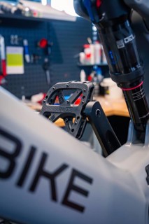 Close-up of a bicycle pedal and frame in a modern workshop, Waldbike Manufaktur, bicycle workshop,