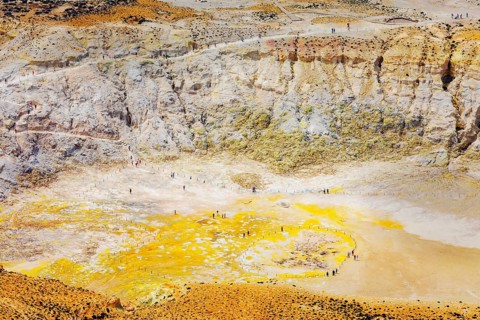 People walking around Stefanos crater moonlike landscape, Nisyros Island, Dodecanese Islands,