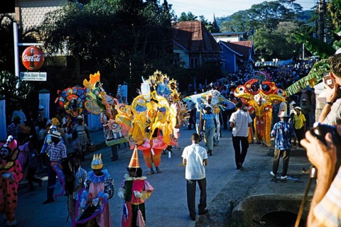 People in colourful costumes at the carnival parade, Port of Spain, Trinidad 1963 with the title