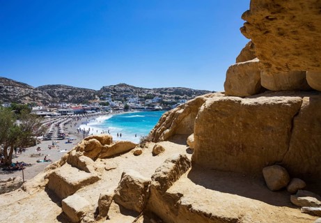View from the rock caves to the beach of Matala, south coast, Crete, Greece, Europe