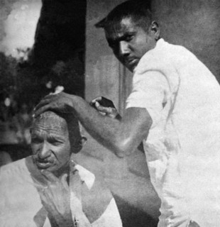 Mahatma Gandhi getting shaved during the salt march, March 1930 - MODEL RELEASE NOT AVAILABLE