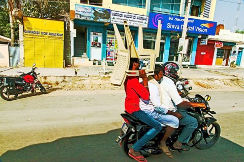 Man carrying plastic chairs on bike, Hubli, Dharwad, Karnataka, India, Asia