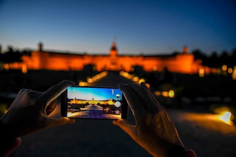 Karlsruhe castle at dusk in the display of a mobile phone, Karlsruhe, Baden-Württemberg, Germany,
