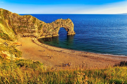 Coastline with bathing beach at Durdle Door, limestone rock bridge, UNESCO World Heritage Site,