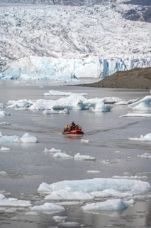 Boats with tourists in the glacier lagoon, ice lagoon Fjallsárlón, ice floes in front of glacier