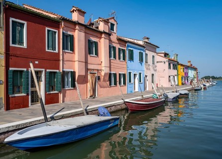 Colourful houses on the canal, canal with boats and colourful house facades, Burano Island, Venice,