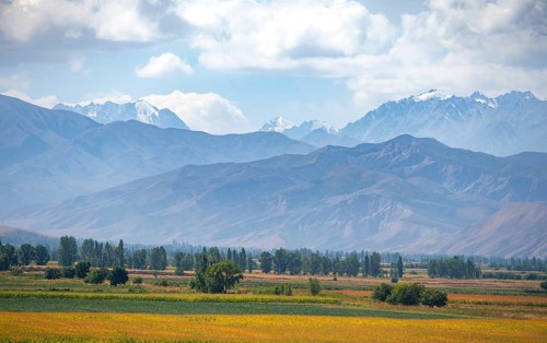 View over fields in the Chüi valley and the mountains of the Kirghiz Ala Too range, near Tokmok,