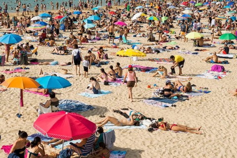 Crowded beach with people in August, San Sebastian, Donostia, Basque Country, Northern Spain,