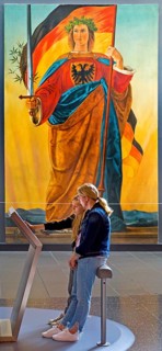 Two woman at a screen in front of the painting of Germania by Philipp Veit, Haus der Geschichte,