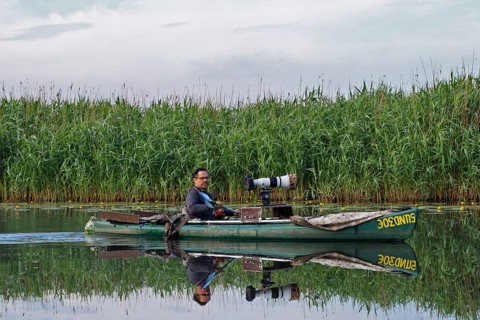 Nature park photographer in a kayak on the river Trebel at work, Naturpark Flusslandschaft
